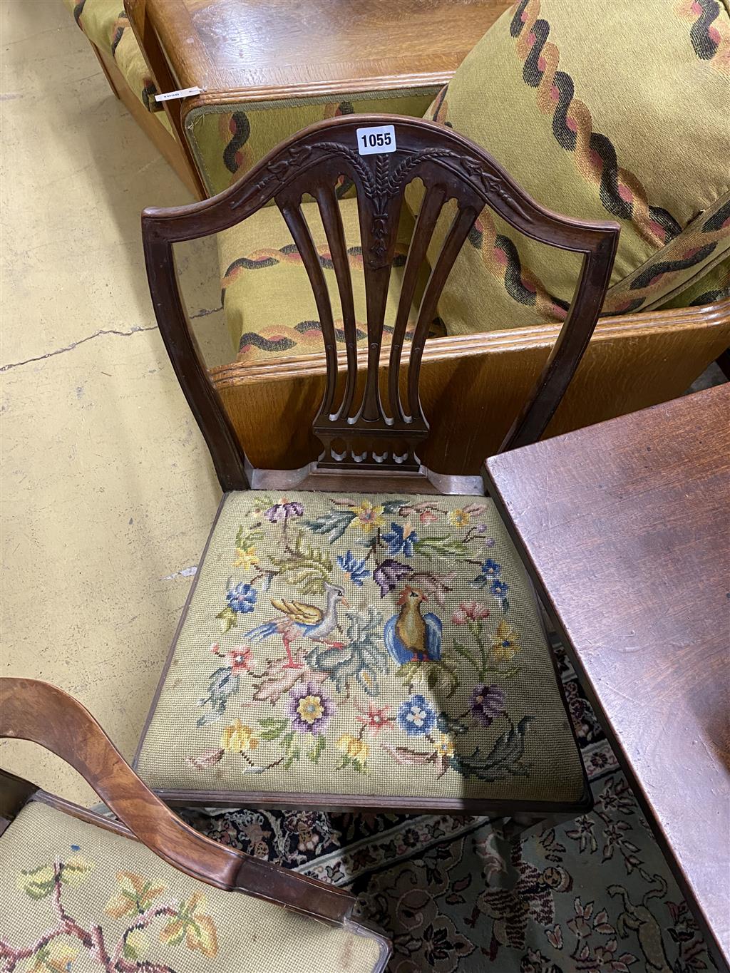 A set of six Hepplewhite style mahogany shield back dining chairs with tapestry drop in seats (two with arms)